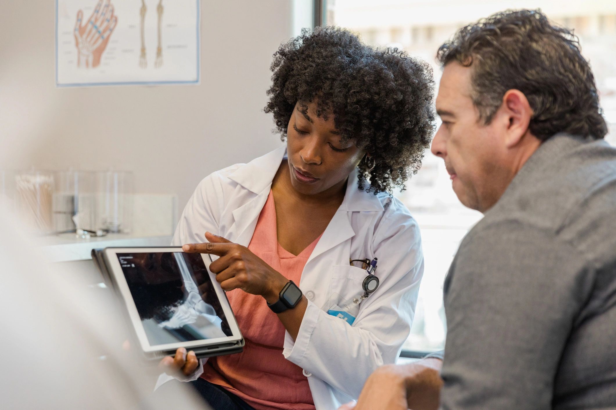 Clinician reviewing imaging results with a patient
