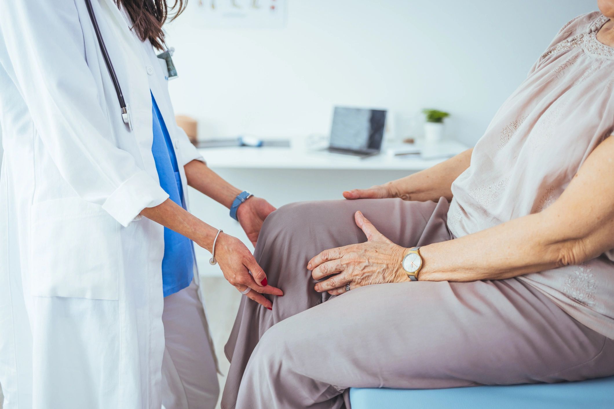 Doctor examining a patient’s knee during an office visit