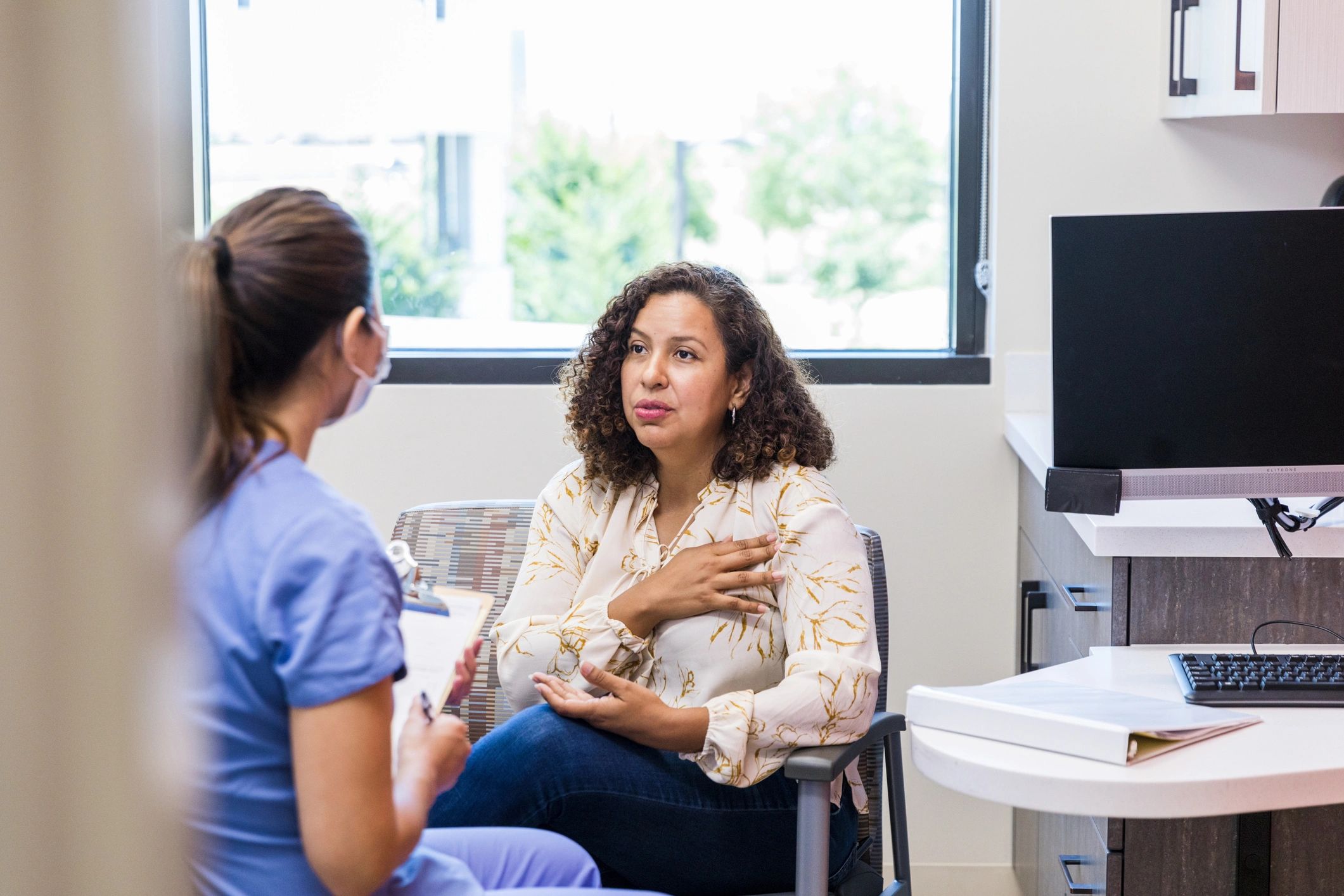Patient discussing symptoms with a nurse