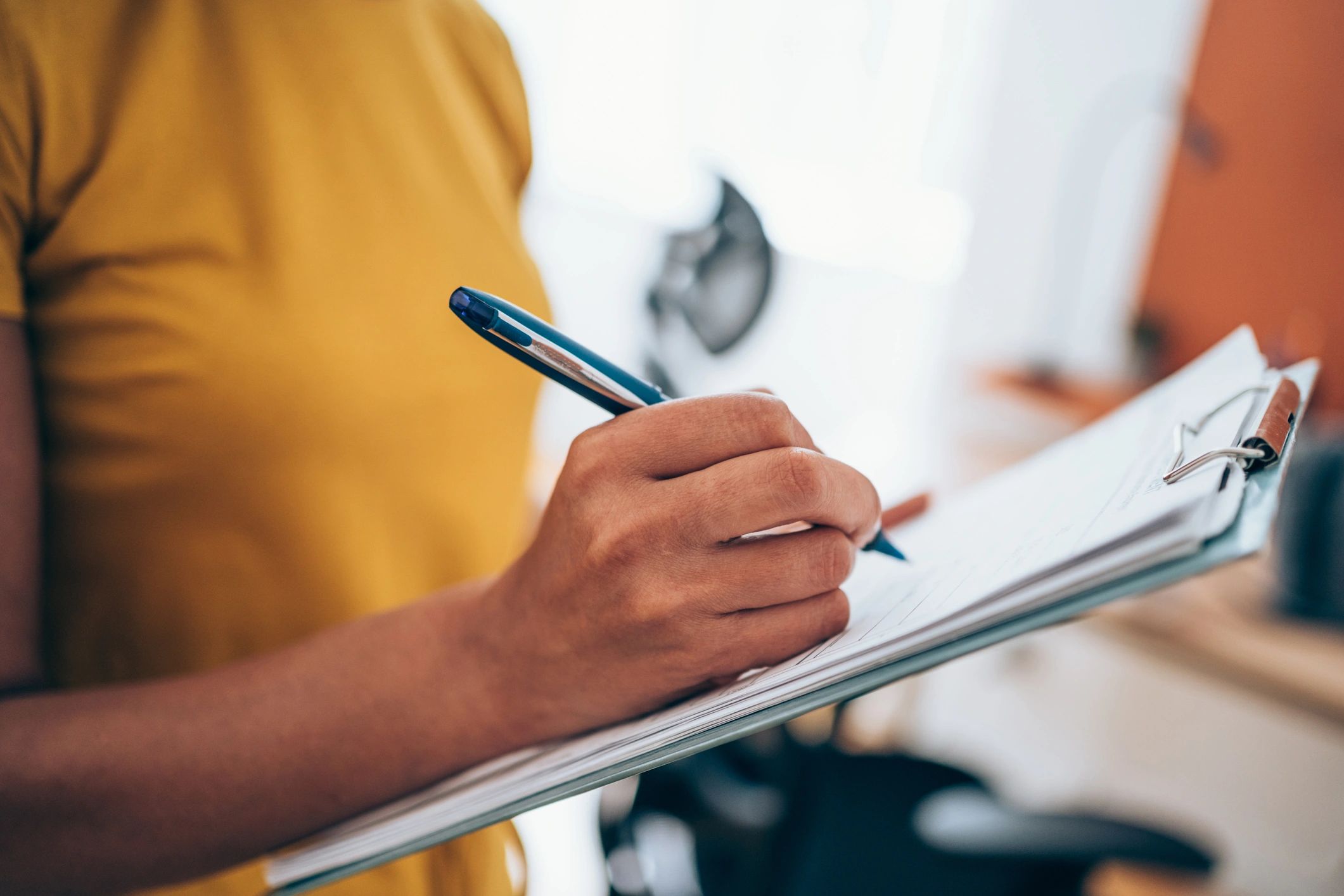 Hand writing on a clipboard form